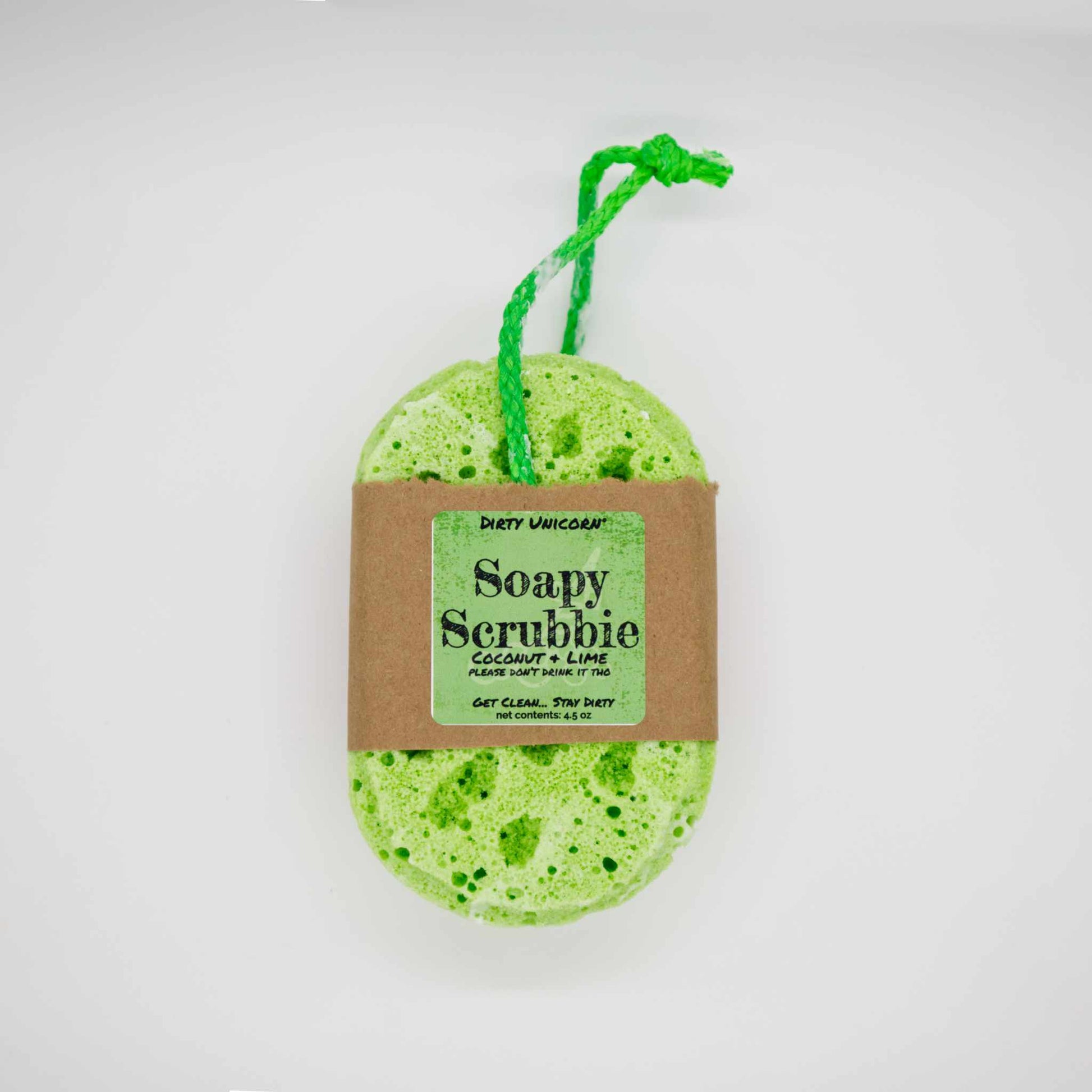 bright green  bath sponge with green rope for hanging on blank white background. Sponge is wrapped in brown Kraft paper belly band with a green label barring product title