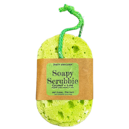 bright green  bath sponge with green rope for hanging on blank white background. Sponge is wrapped in brown Kraft paper belly band with a green label barring product title
