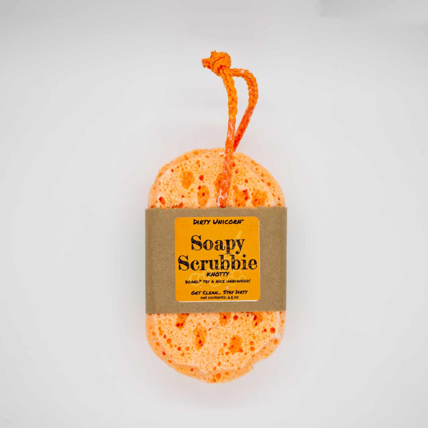 bright orange bath sponge with coordinating rope for hanging. on blank white background. Sponge is wrapped in brown Kraft paper belly band with an orange label barring product title